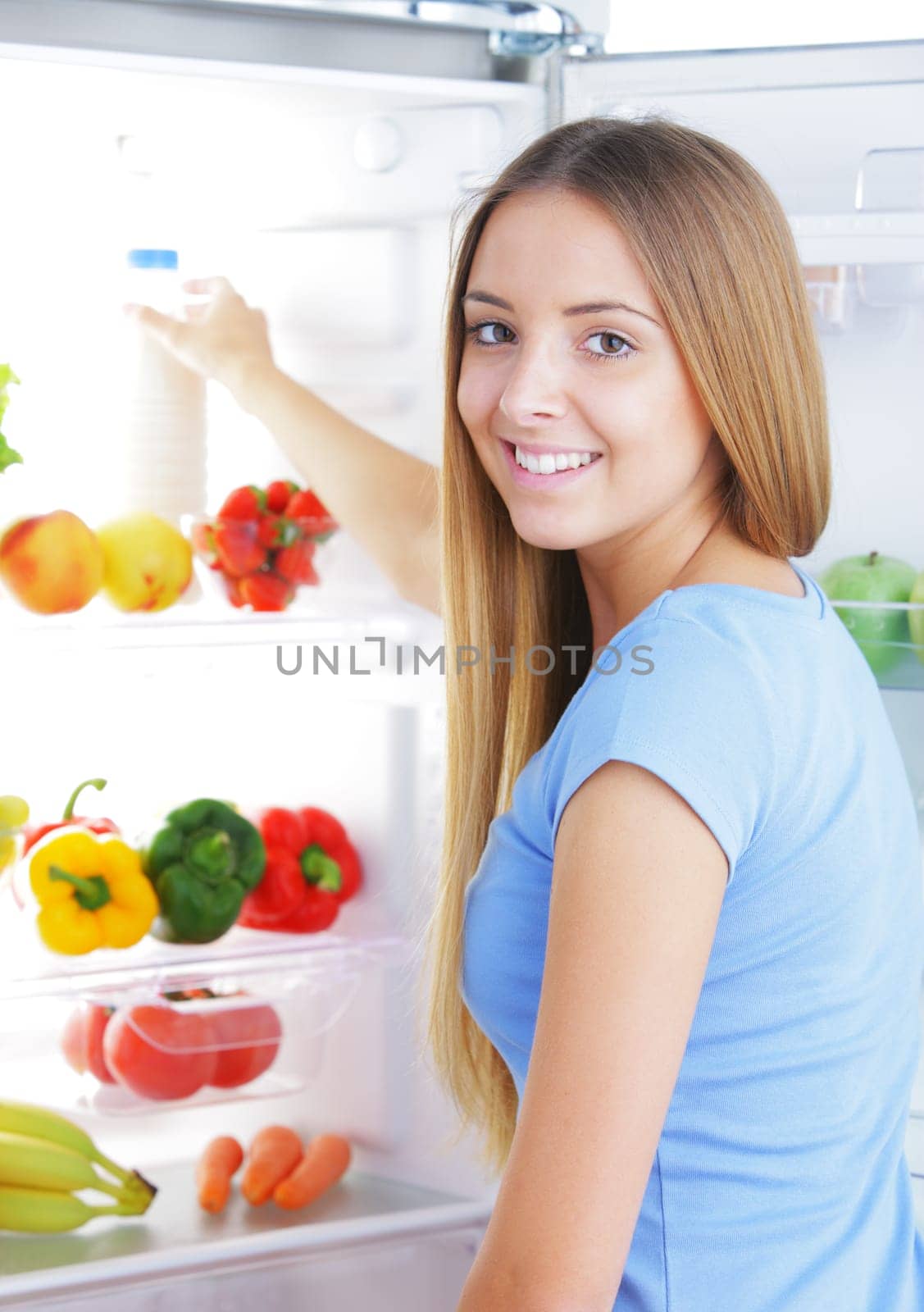 Young woman takes a bottle of milk