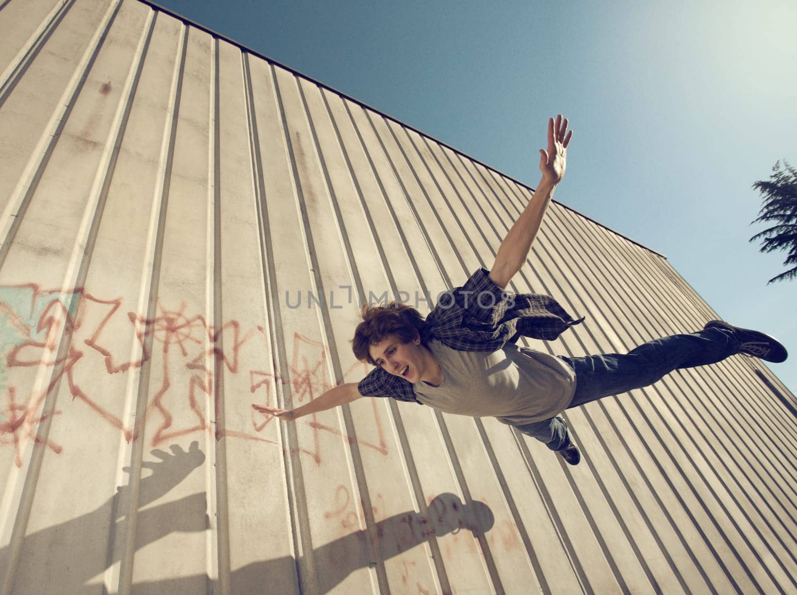 Young man flying with open arms