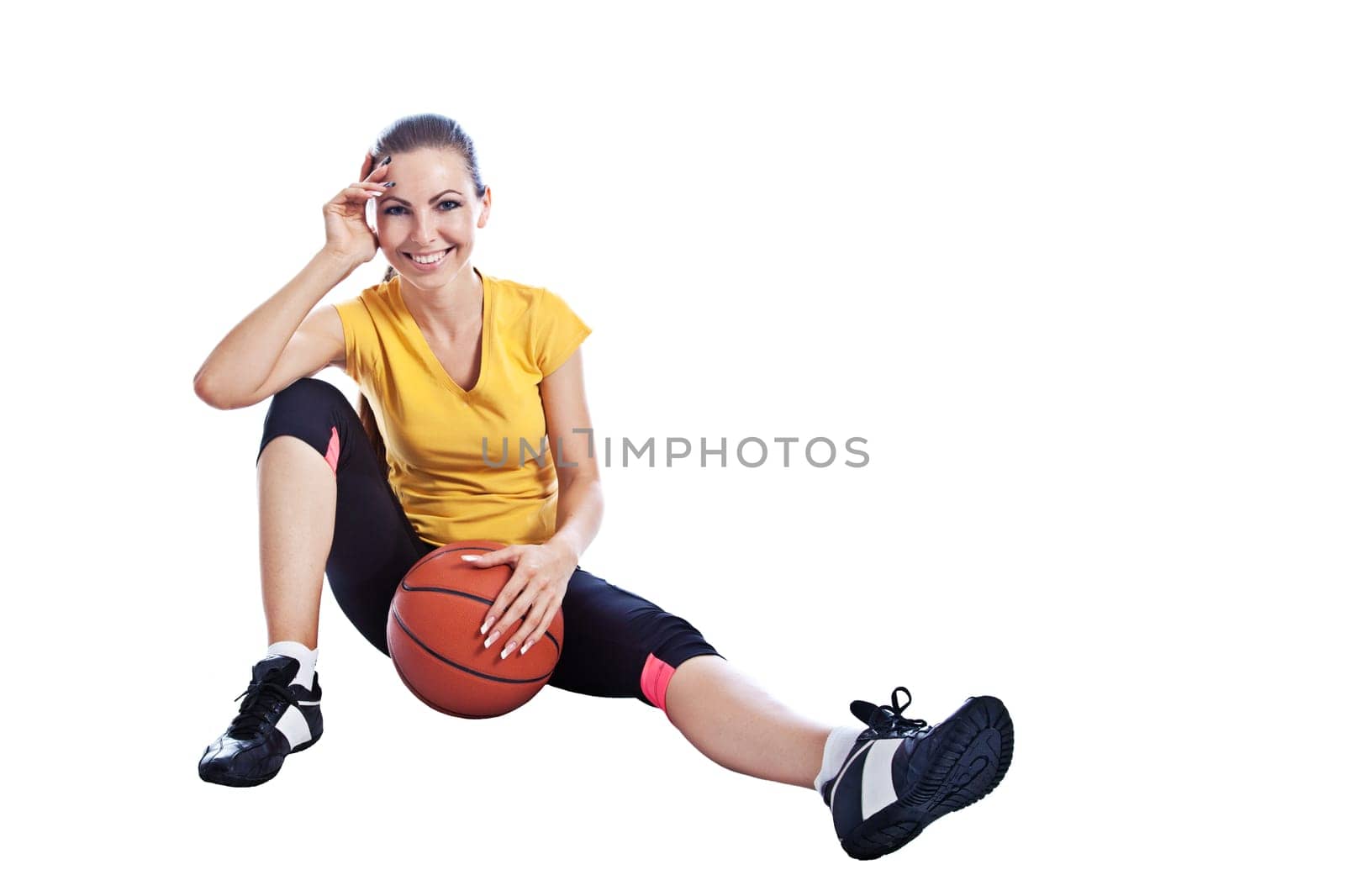 Isolated young beautiful girl in athletic wear with basketball
