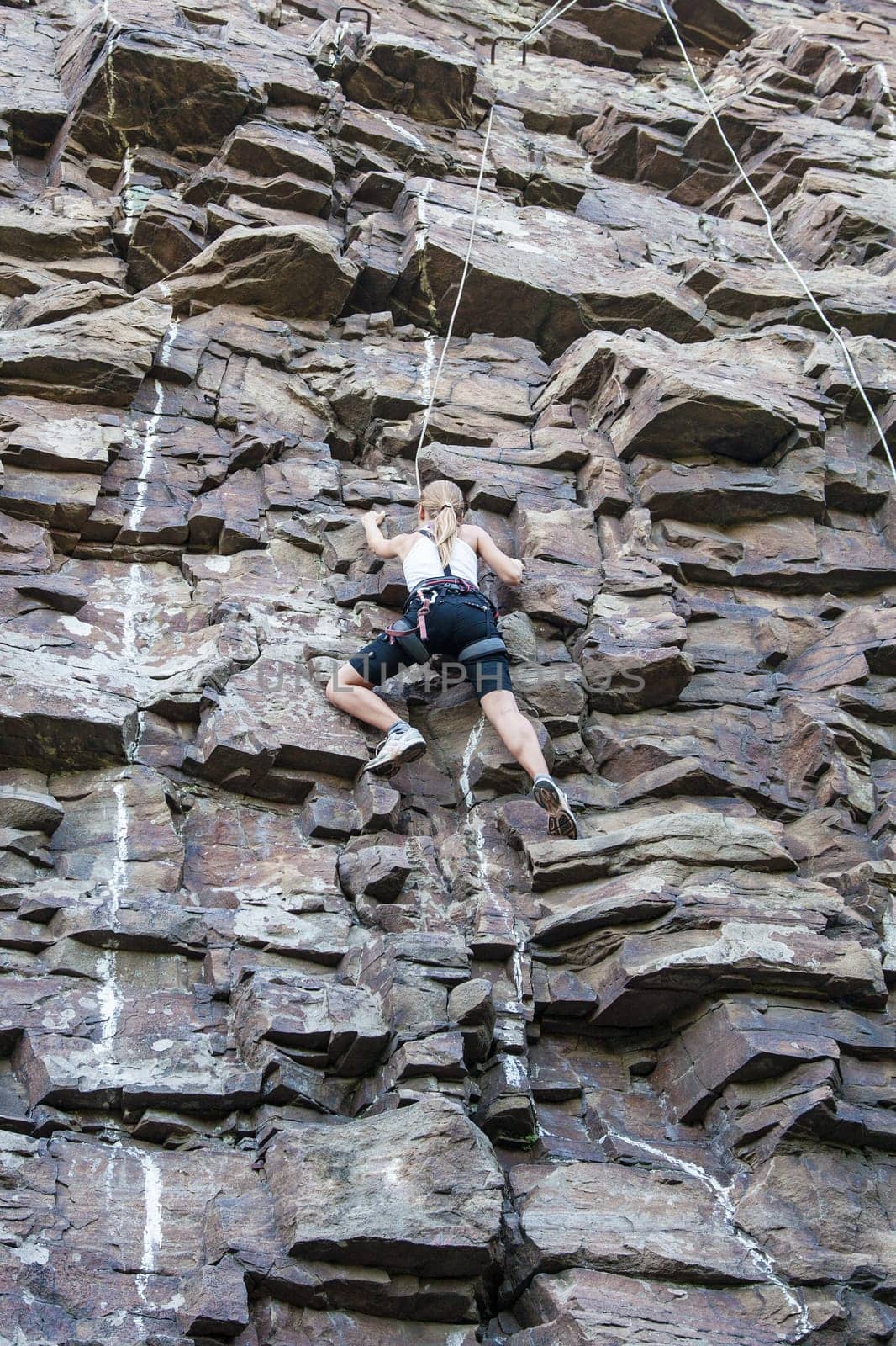 Extreme rock climber reaching for the summit