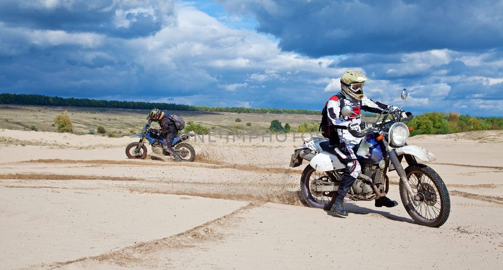Enduro bike riders driving through the desert