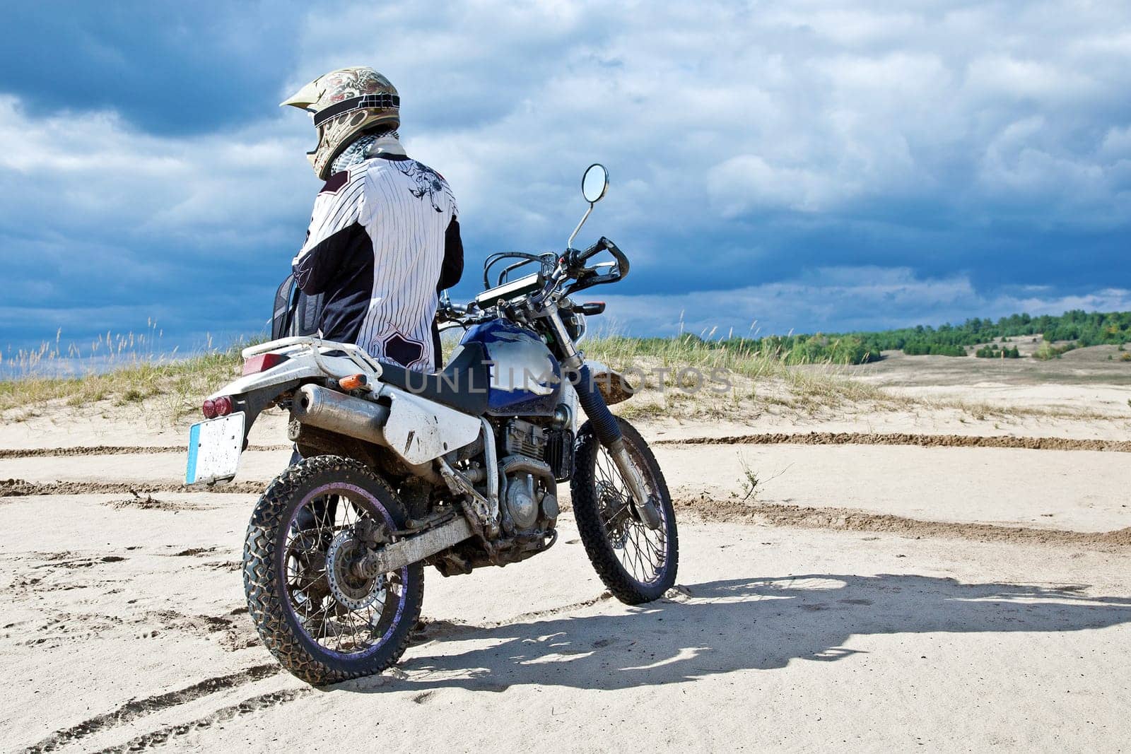 Enduro bike rider driving across the desert