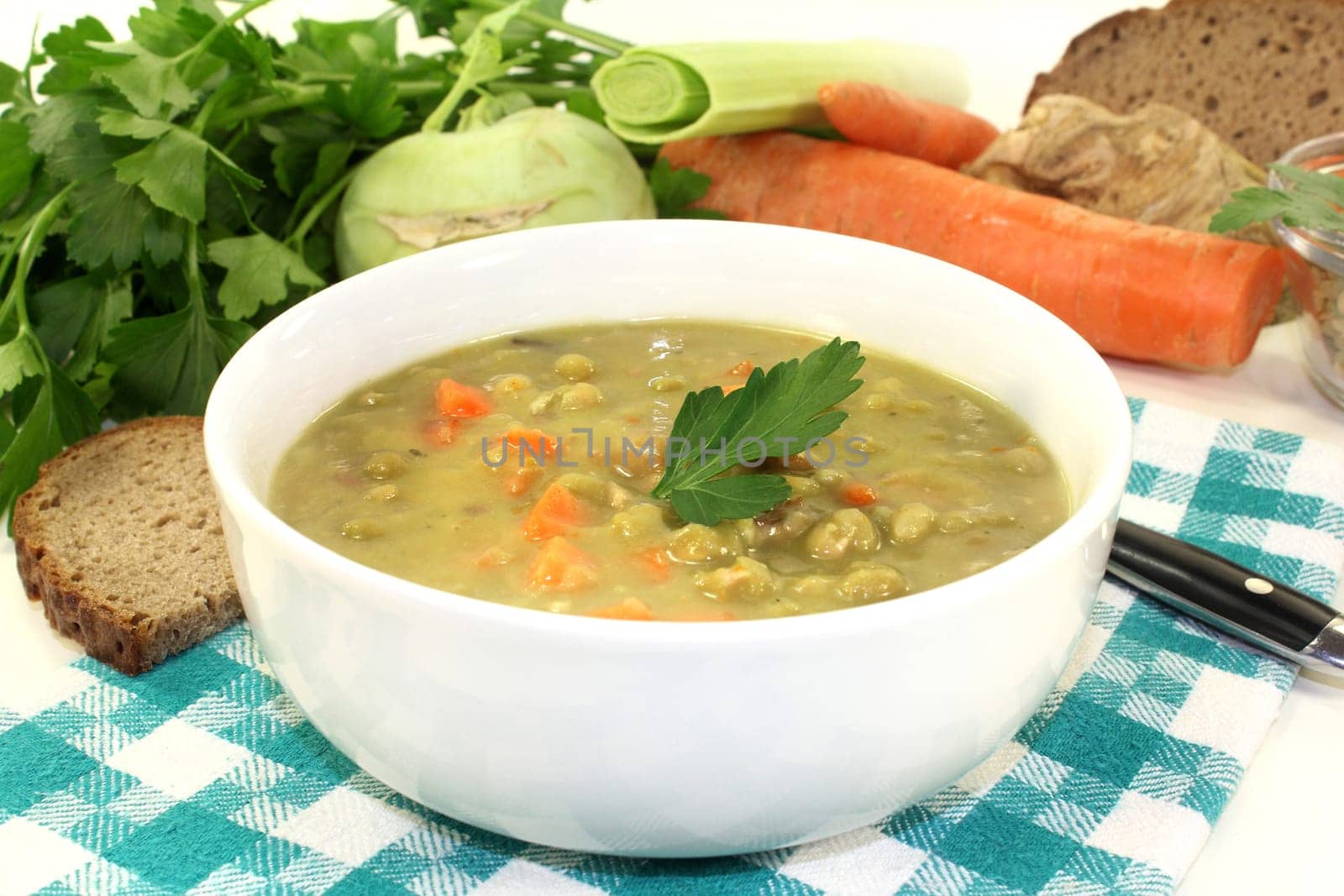 a white bowl with pea stew and parsley