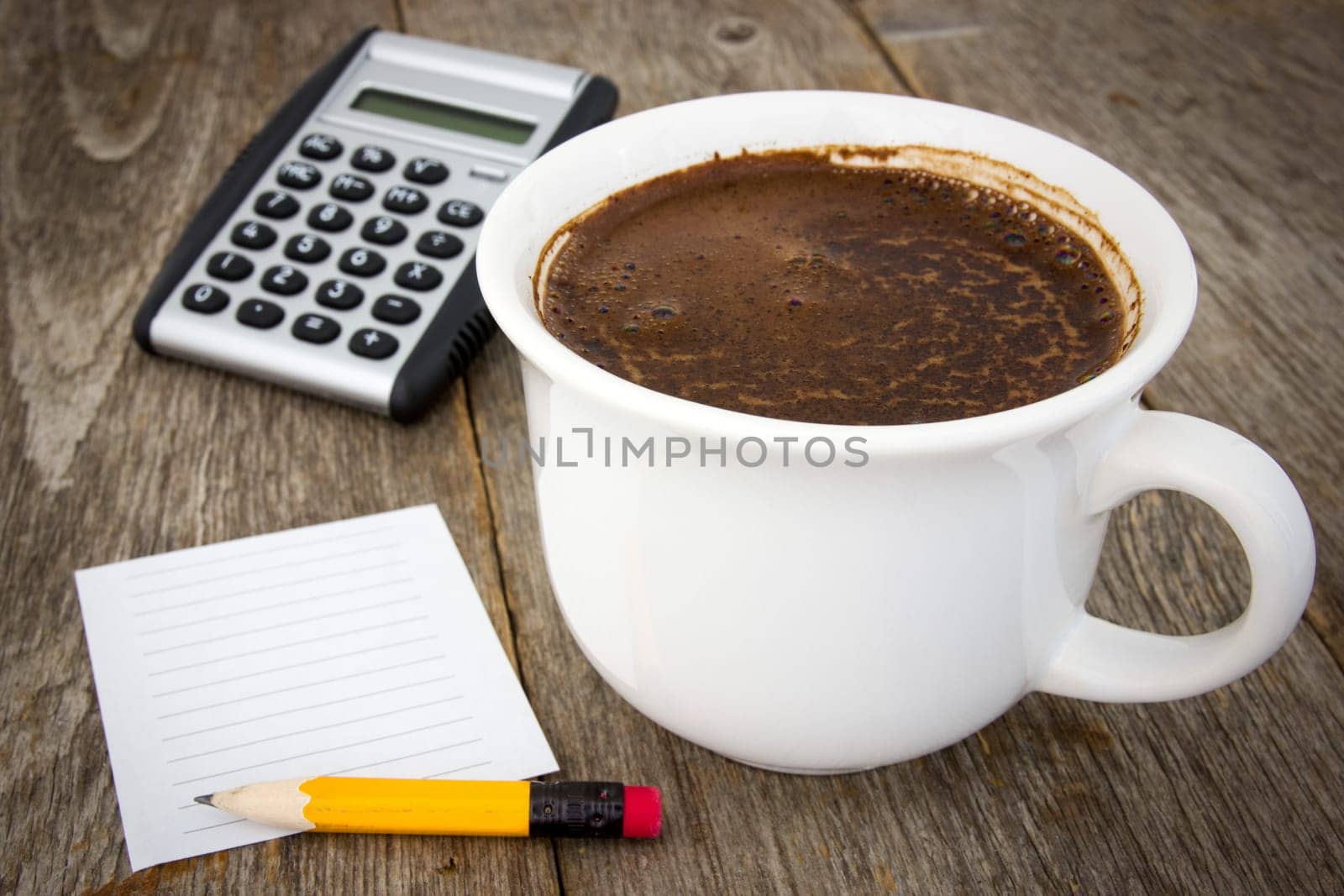 Coffee cup, calculator  and empty paper sheet with pencil on wooden background