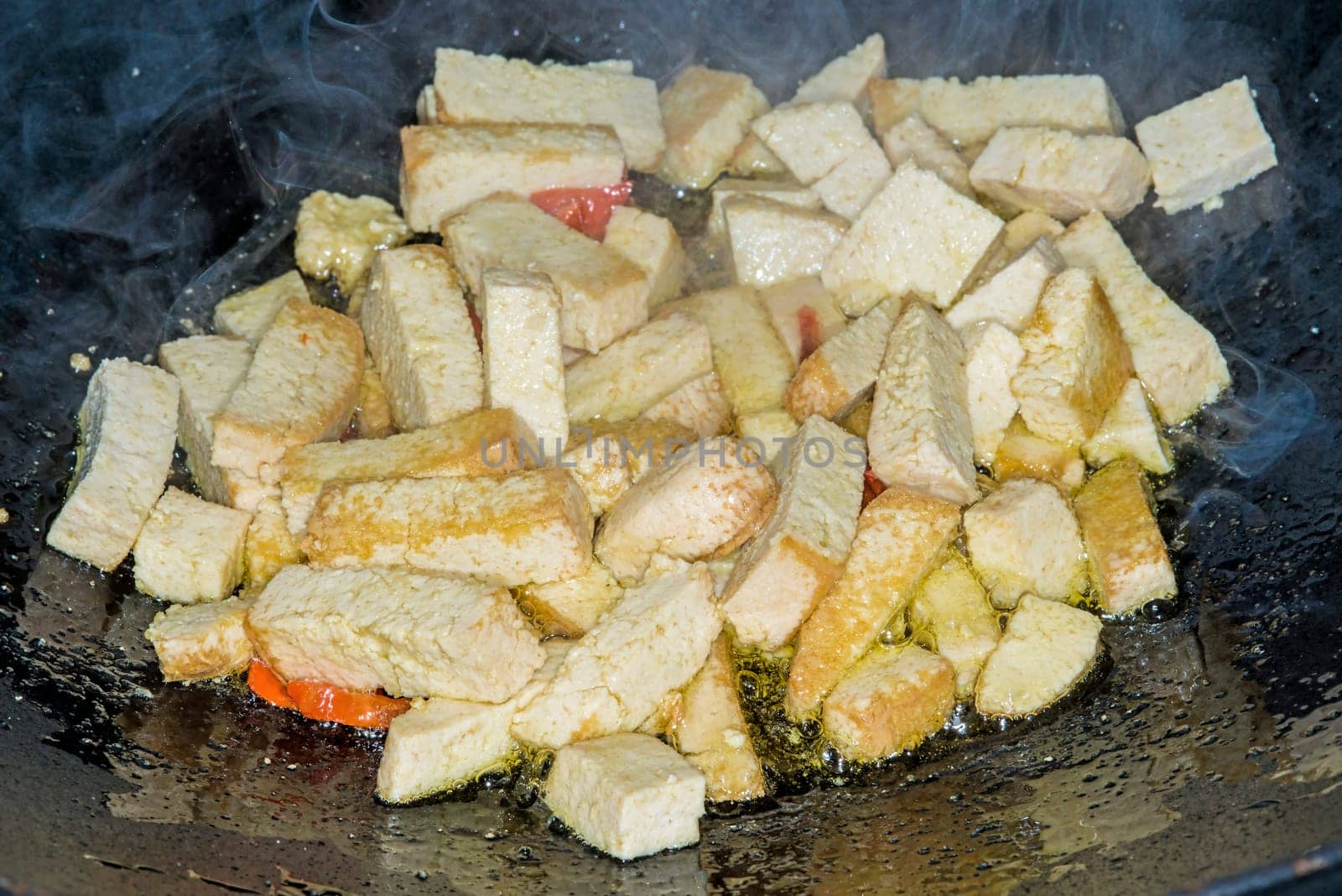 Tofu in wok.