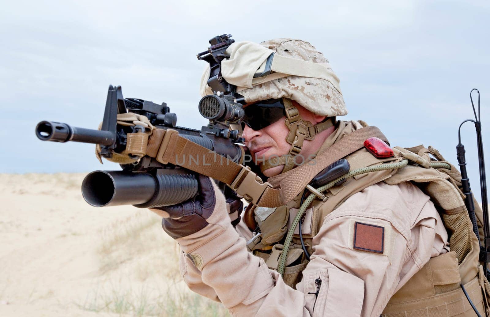 US marine aiming a gun with grenade launcher