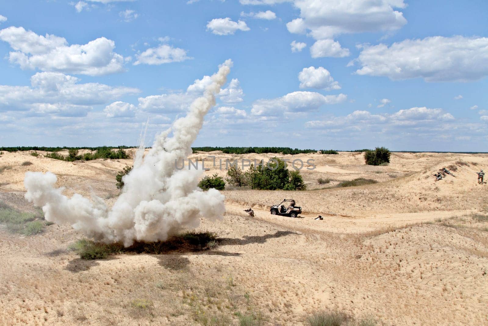 Large explosion near the car with soldiers in the desert