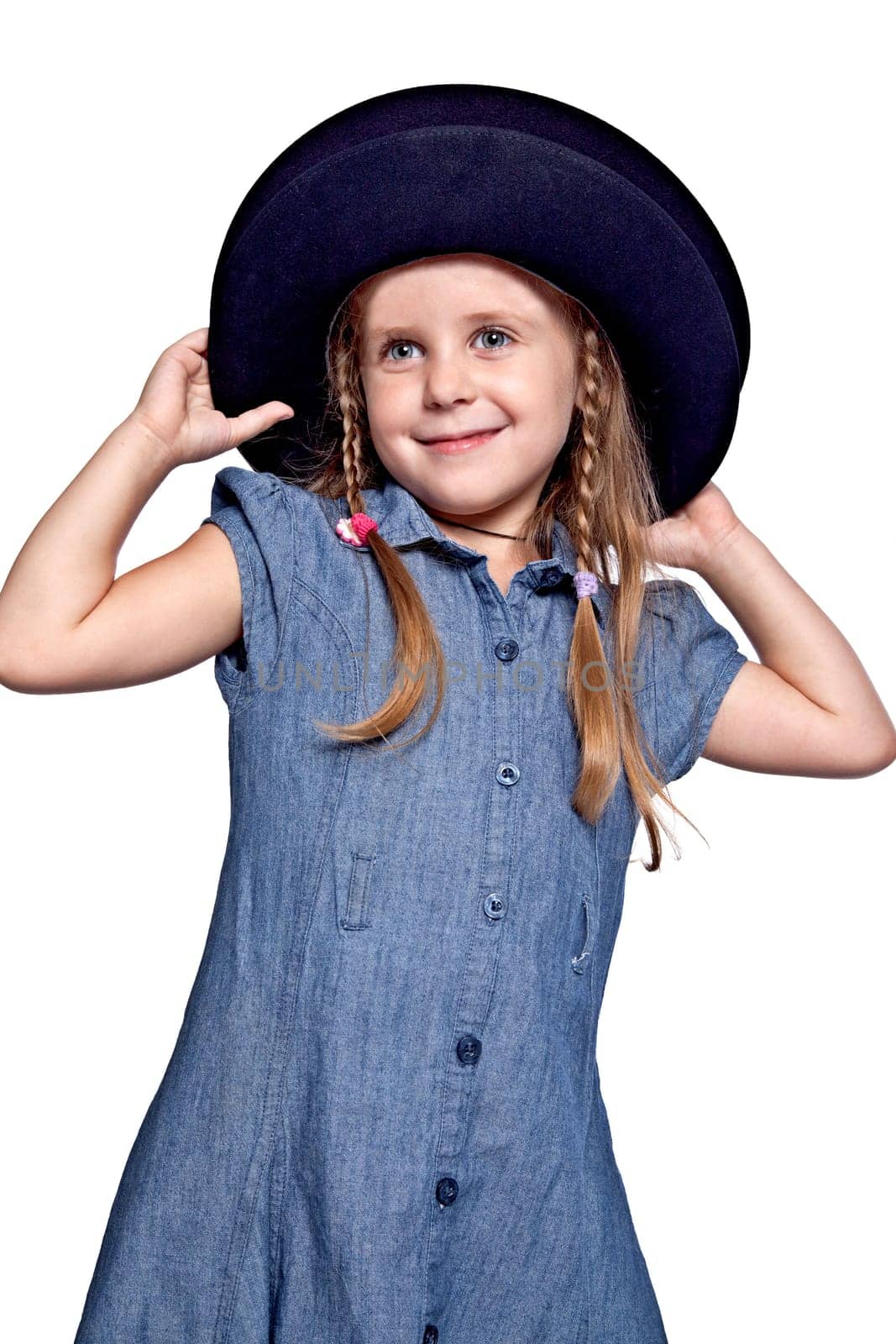 little girl in blue dress wearing the big black hat