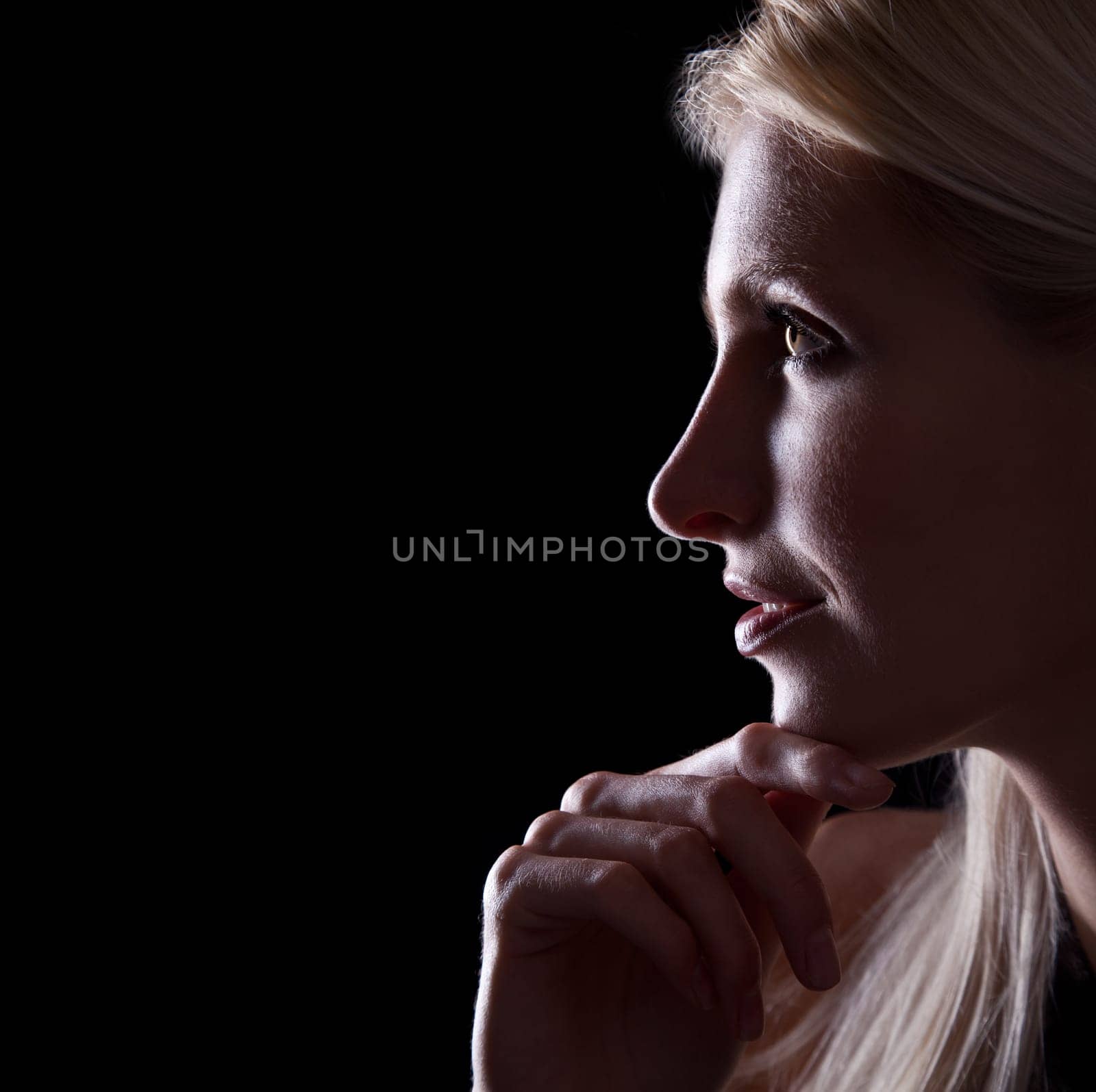 Backlit portrait of caucasian woman profile on black background