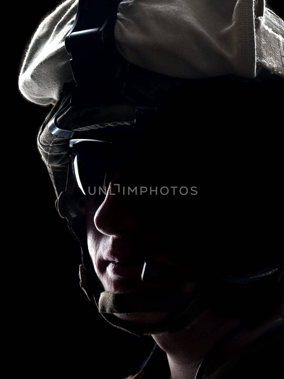 US soldier on the black background with the lot of copyspace