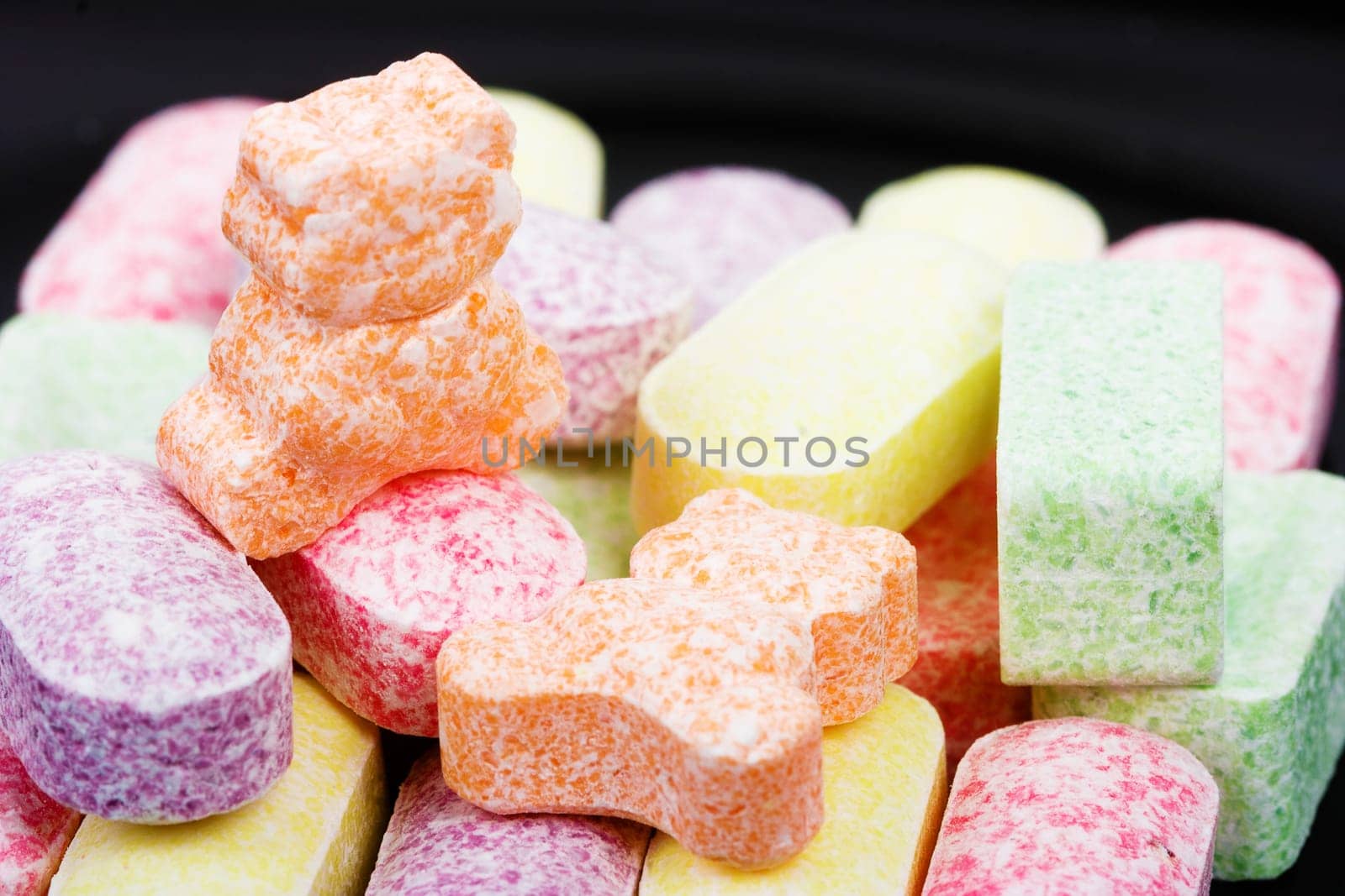 colorful different shapes candy on a black background