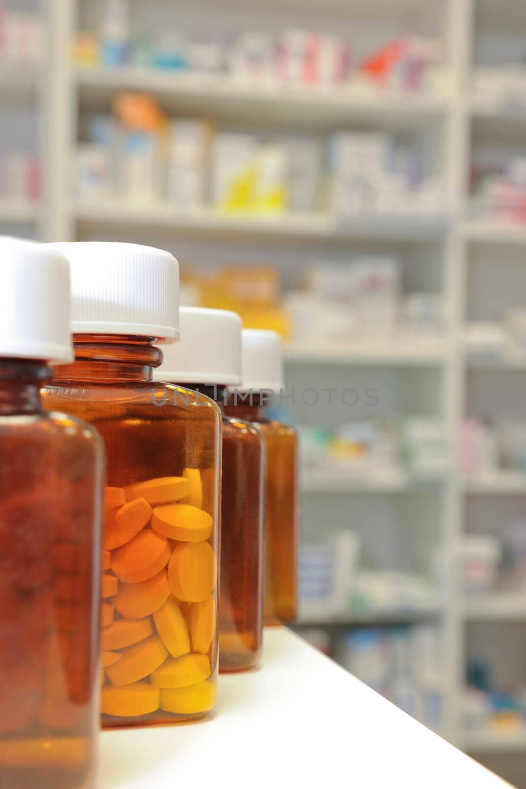 row of bottles and pills on a chemists counter