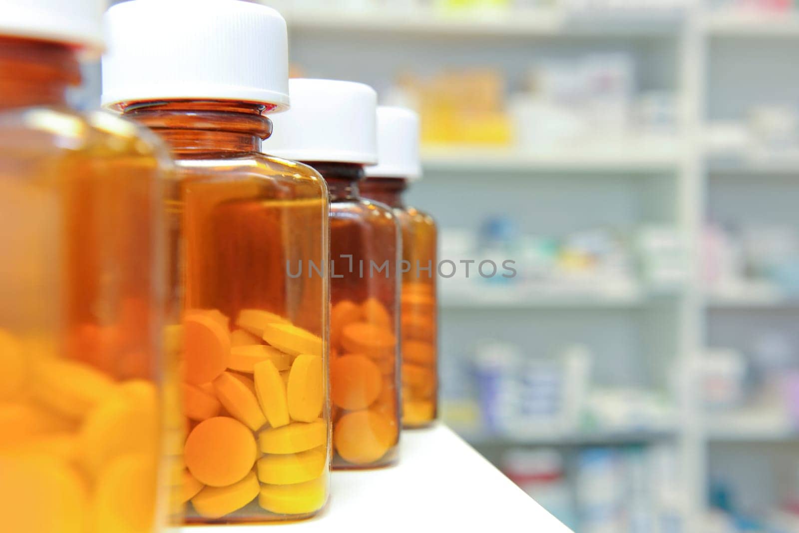 row of bottles and pills on a chemists counter