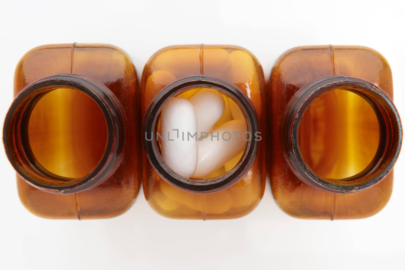 overhead view of pill bottles on white background