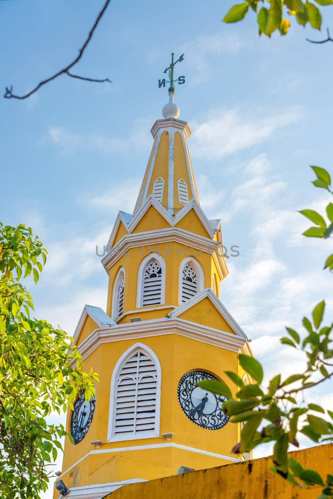 Yellow clocker tower marking the main entrance into the historic old town of Cartagena, Colombia