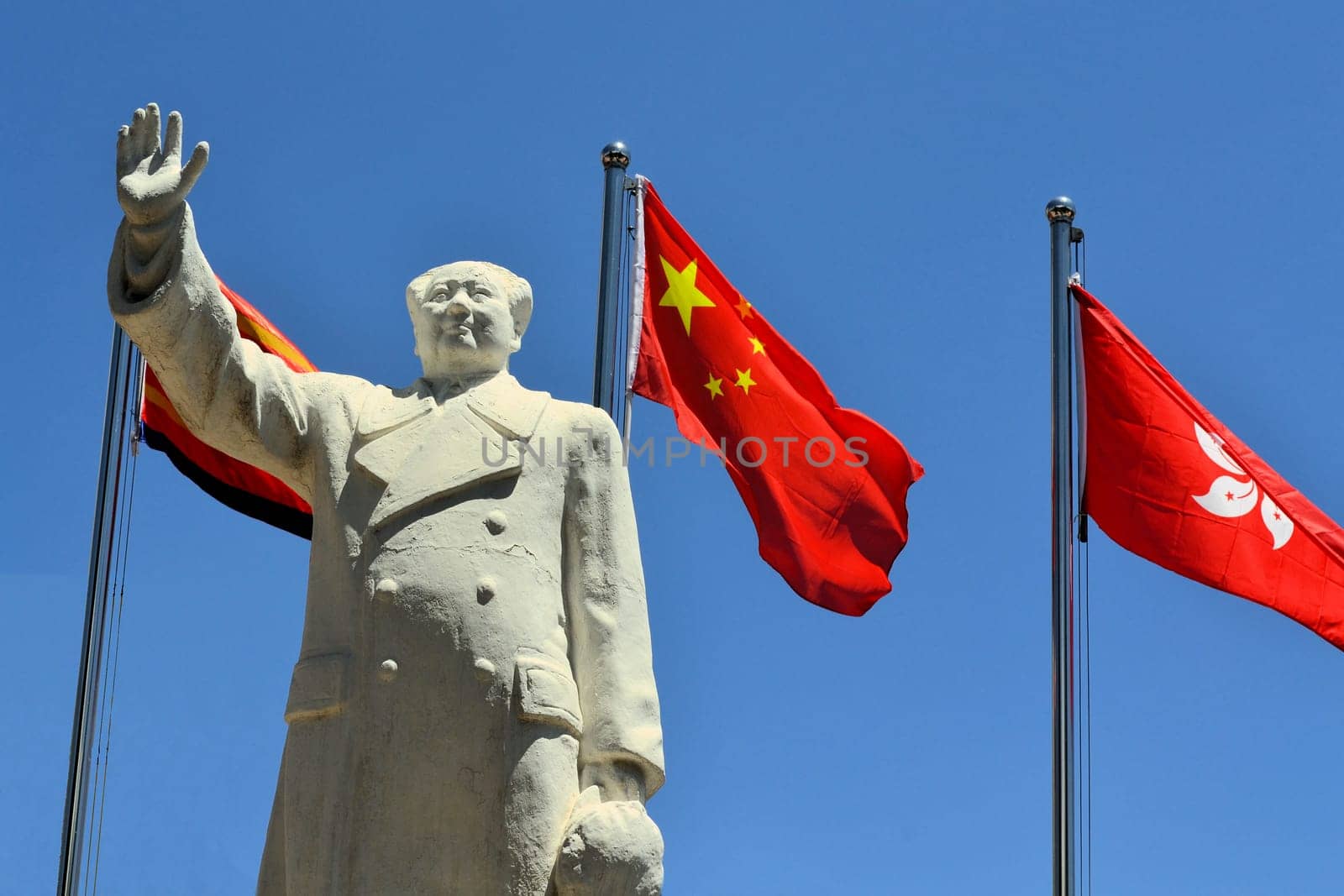 A Statue of China's former Chairman Mao Zedong with Chinese flagin the city of Lijang, China