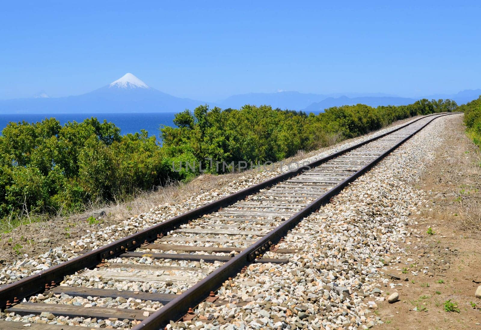 Railroad in front of volcaon Osorno and lake Llanquihue near Puerto Varas, Chile
