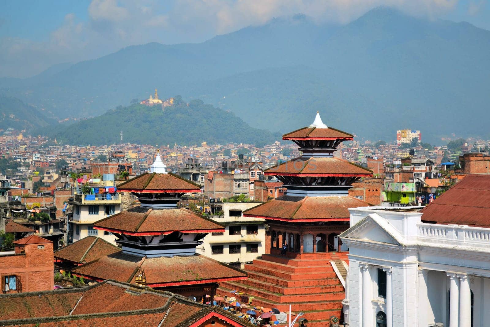 View of the UNESCO world heritage site Durbar Square in Kathmandu, with the hill temple Swayambhunath in the distant hills.