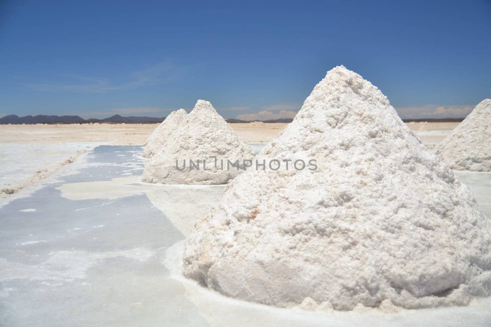 Heap of sea salt in a Bolivian salt flat prepared for harvest