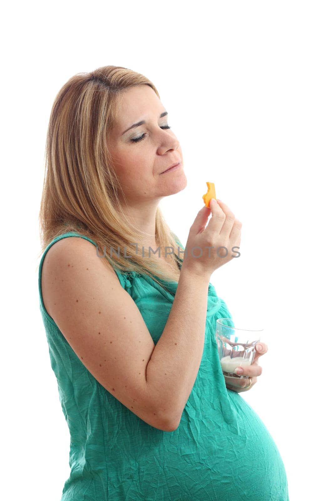 Details of a pregnant woman with a glass of milk and cheese isolated on white background.