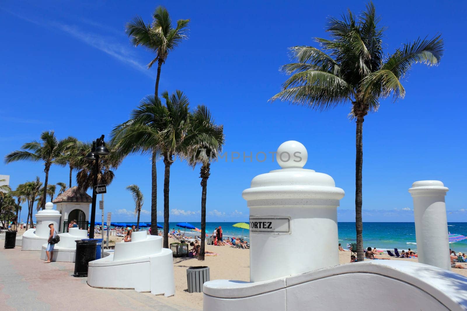 FORT LAUDERDALE, FLORIDA - APRIL 8, 2013: Many people relaxing, suntanning enjoying spring break at the popular tropical public beach on a warm and sunny day near Cortez Street and State Road A1A.