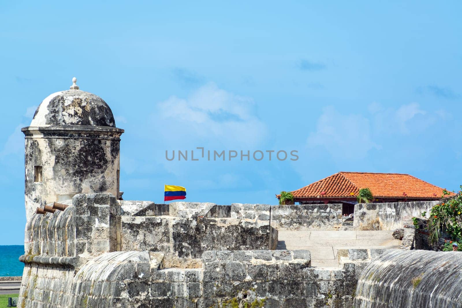 Defensive wall surrounding the historic center of Colombia with a Colombian flag waving in the breeze