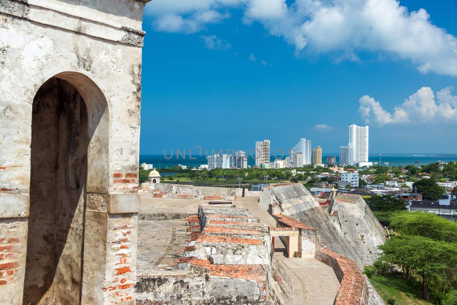 San Felipe de Barajas castle in Cartagena, Colombia with modern high rise apartment buildings visible in the background