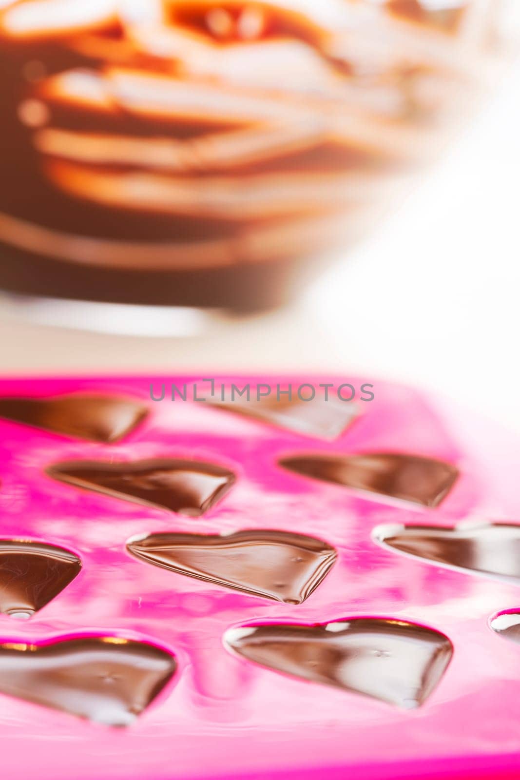 Warm chocolate just poured into chocolate mold.