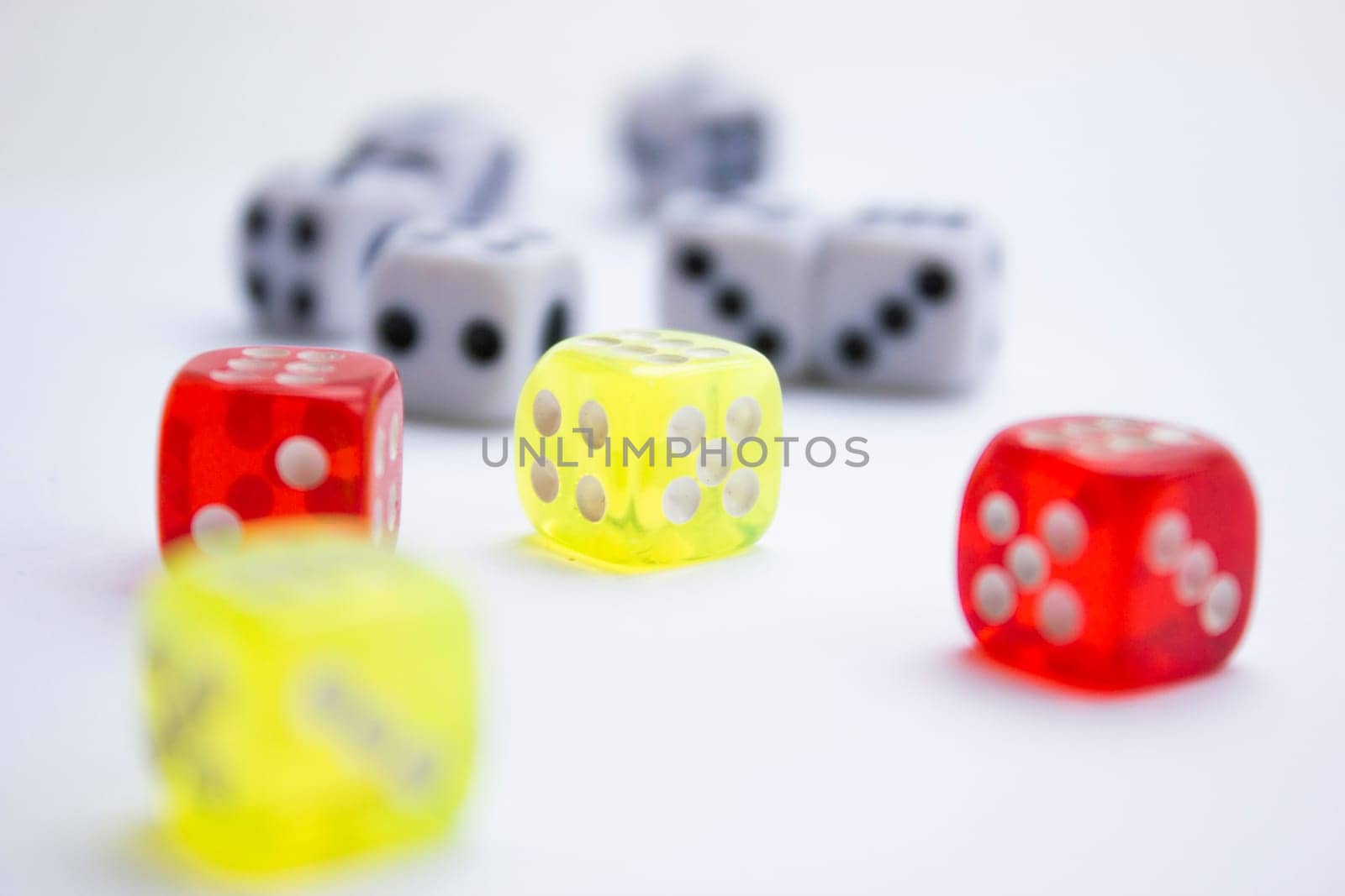 Composition from different colored dice on a white background.