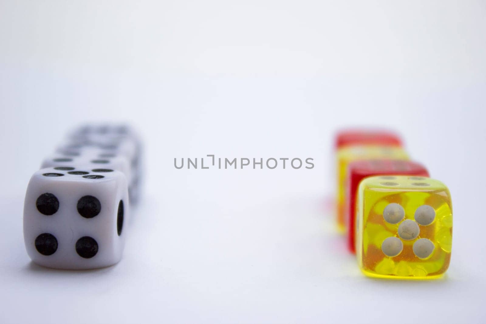 Composition from different colored dice on a white background.