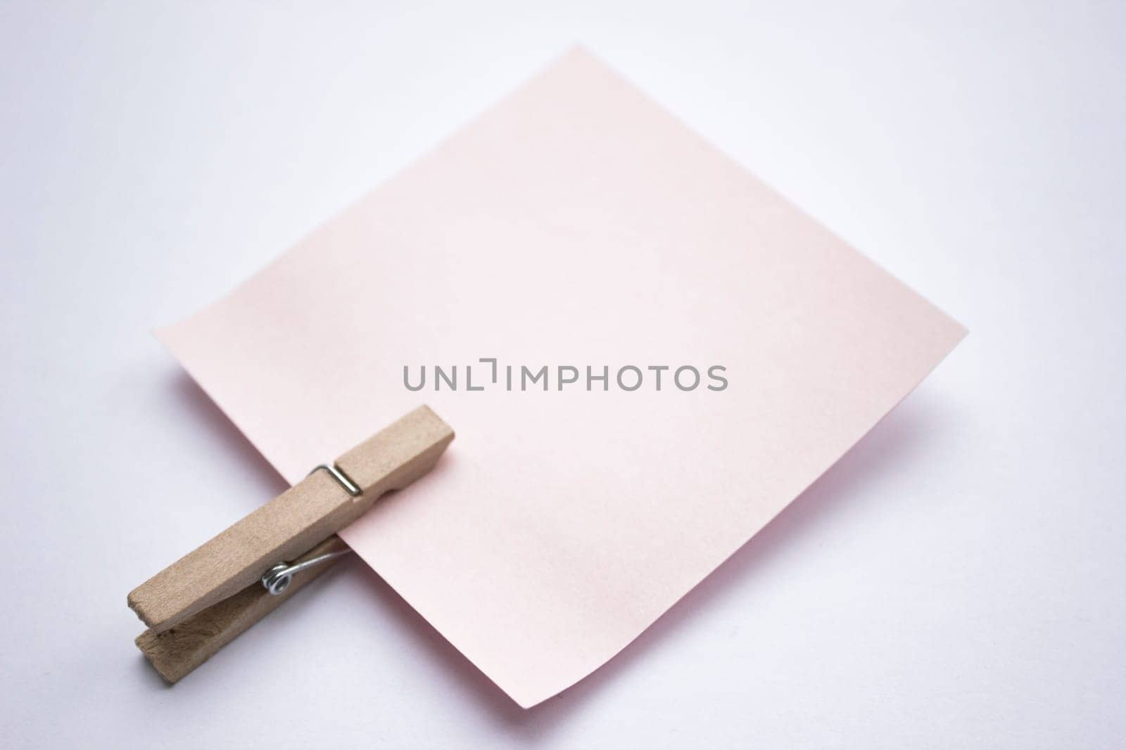 A reminder note pinned with a wooden peg on the side.