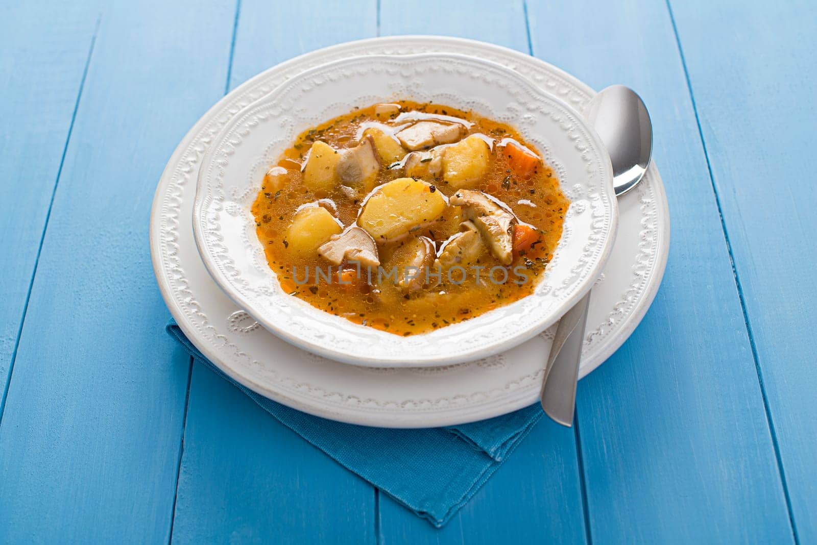 Hot mushroom soup decorated on blue background