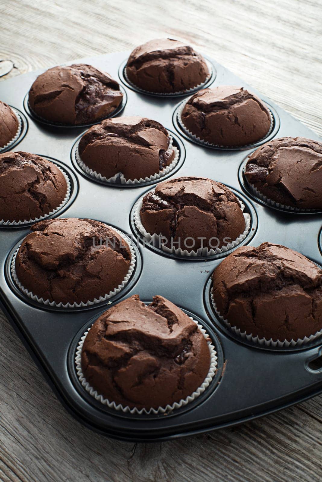 Fresh chocolate muffins in a tray close up shoot