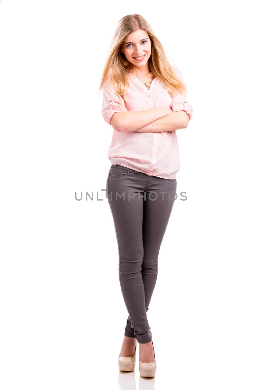 Beautiful and attractive fashion woman smiling and posing, isolated over white background