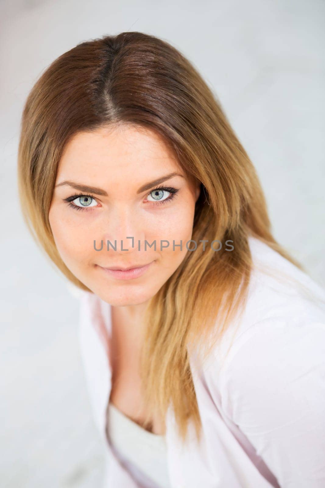 Focused look of pretty woman in white suit