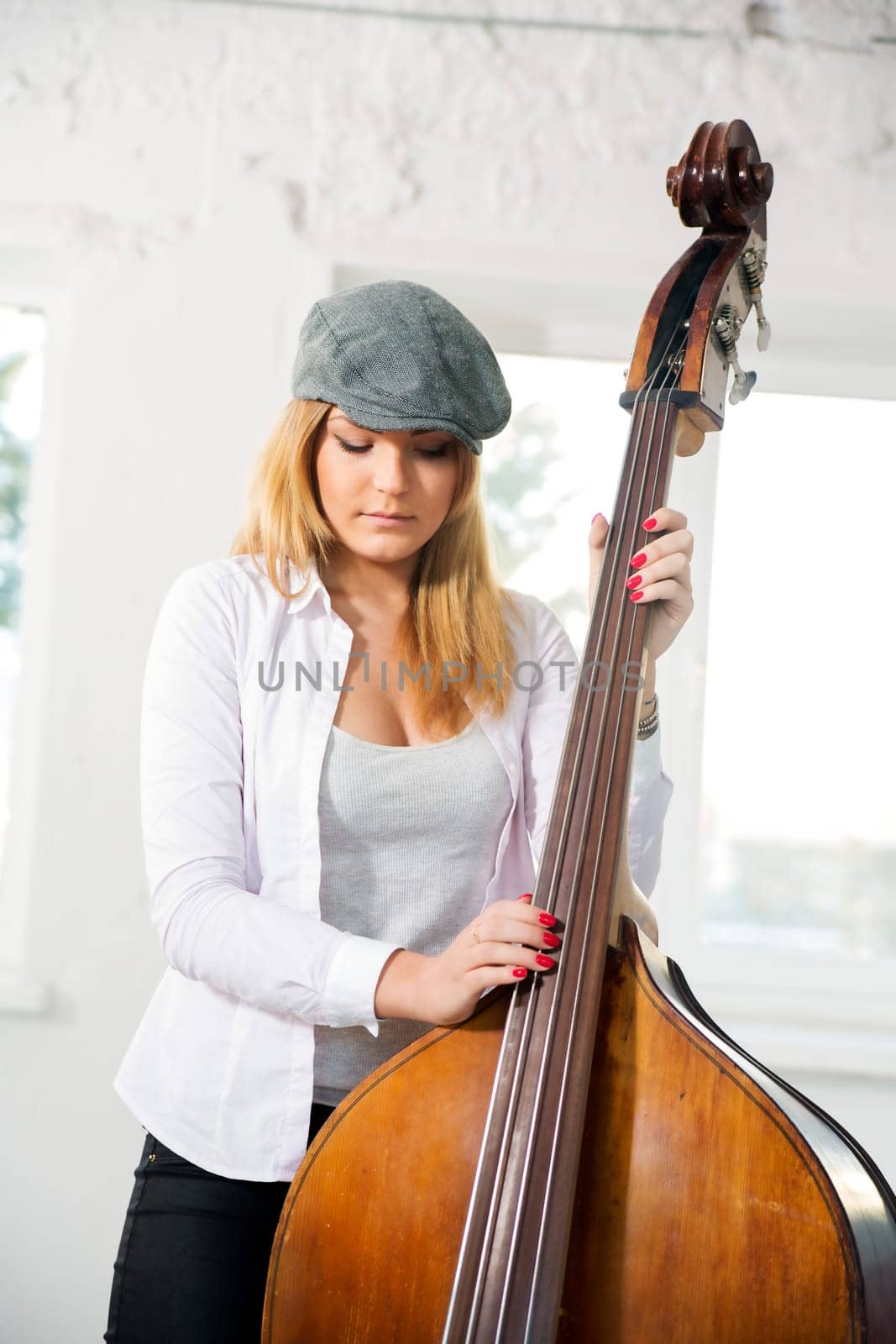 Charming woman at sunny day hold contrabas gently