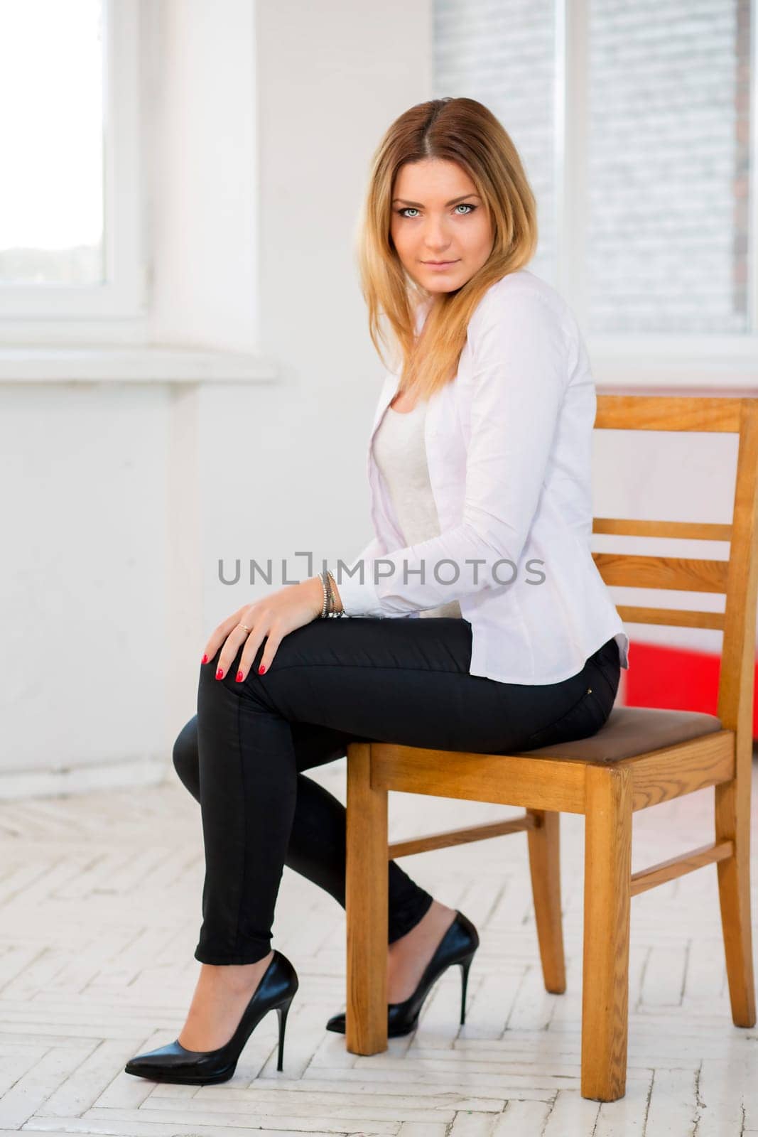 Charming woman in white suit with serious look