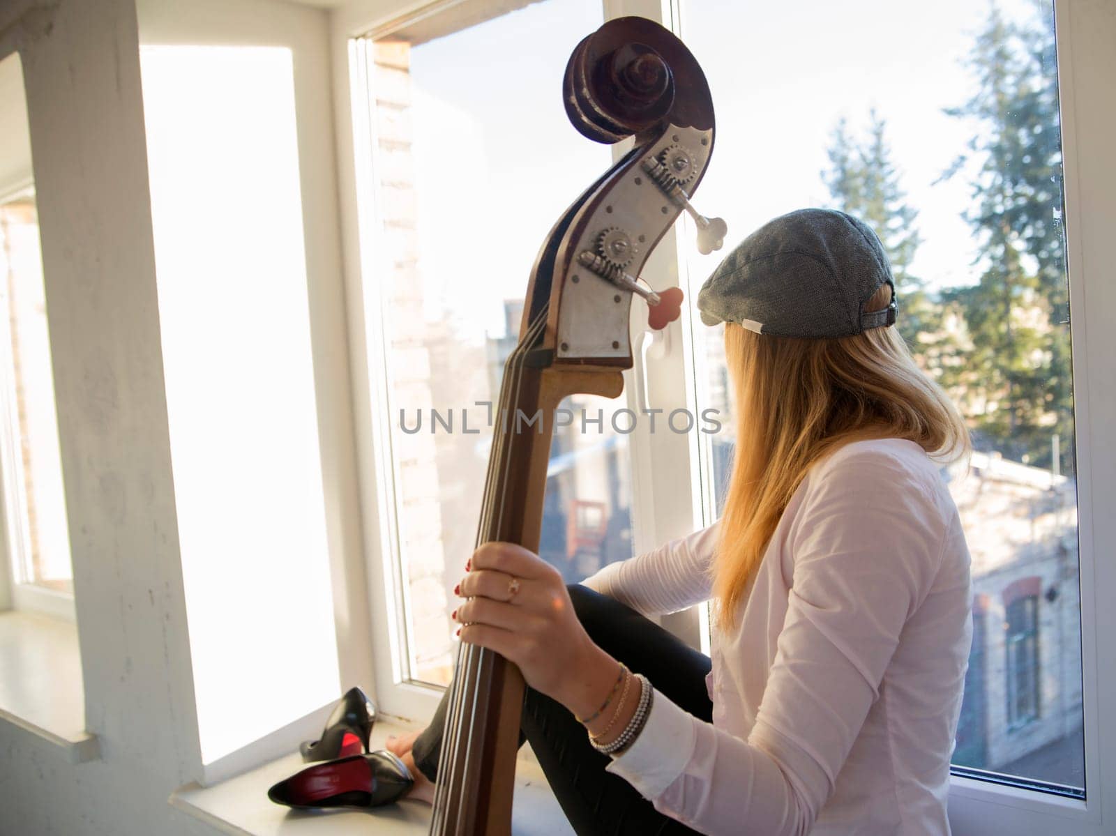Charming woman on windowsill and fine weather
