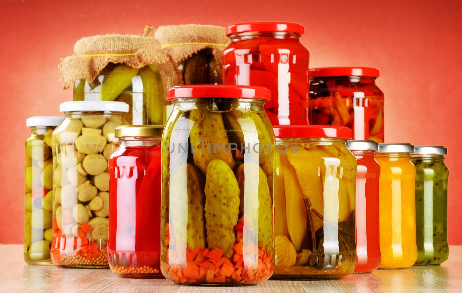 Composition with jars of pickled vegetables. Marinated food