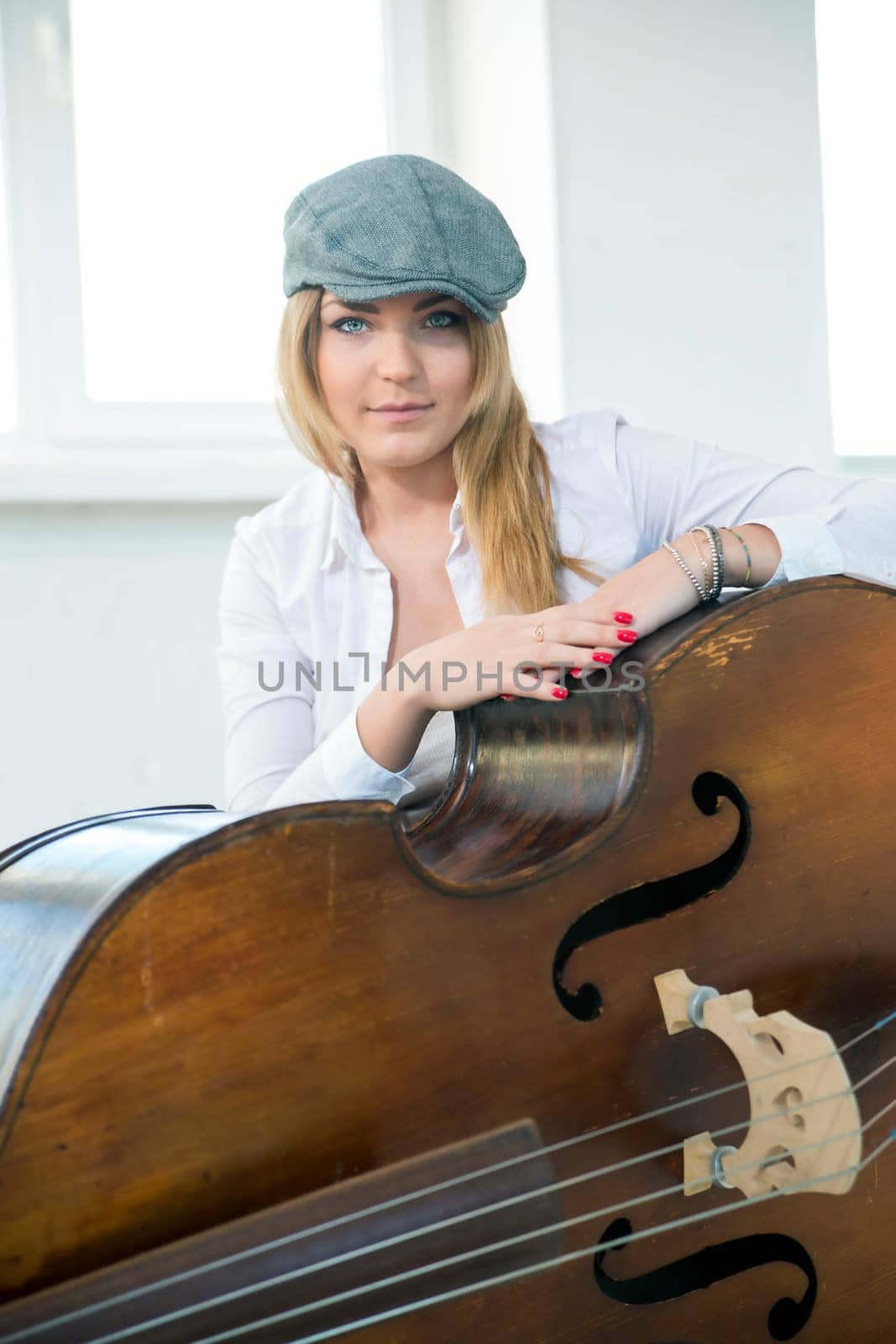 Charming woman and big contrabas at front view