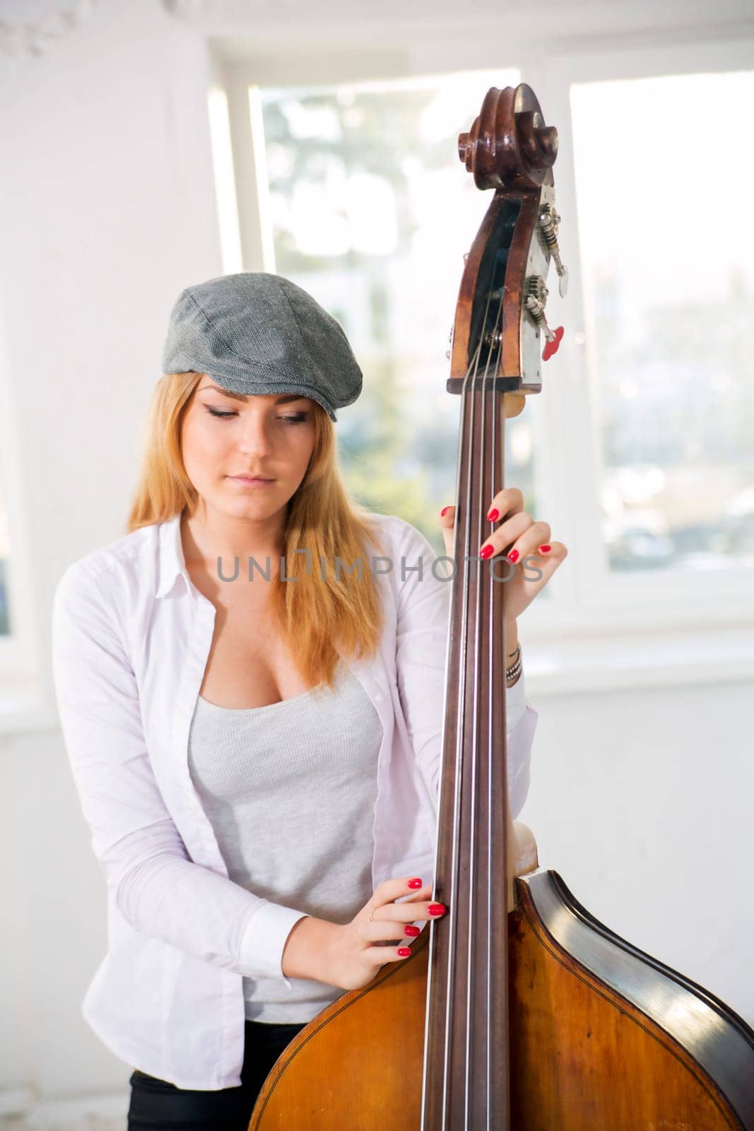 Charming woman at sunny day hold on contrabas