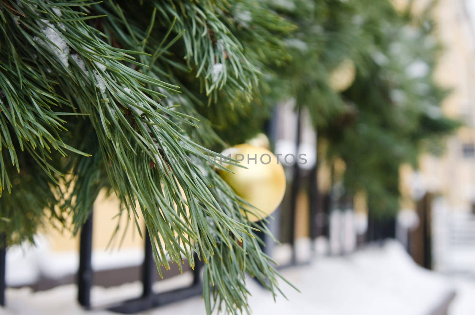 Christmas fir tree decorated with balloons and is sprinkled with snow