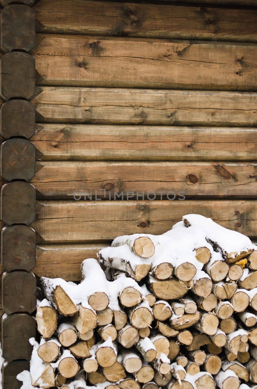 Birch fire wood at a wall of the house in winter