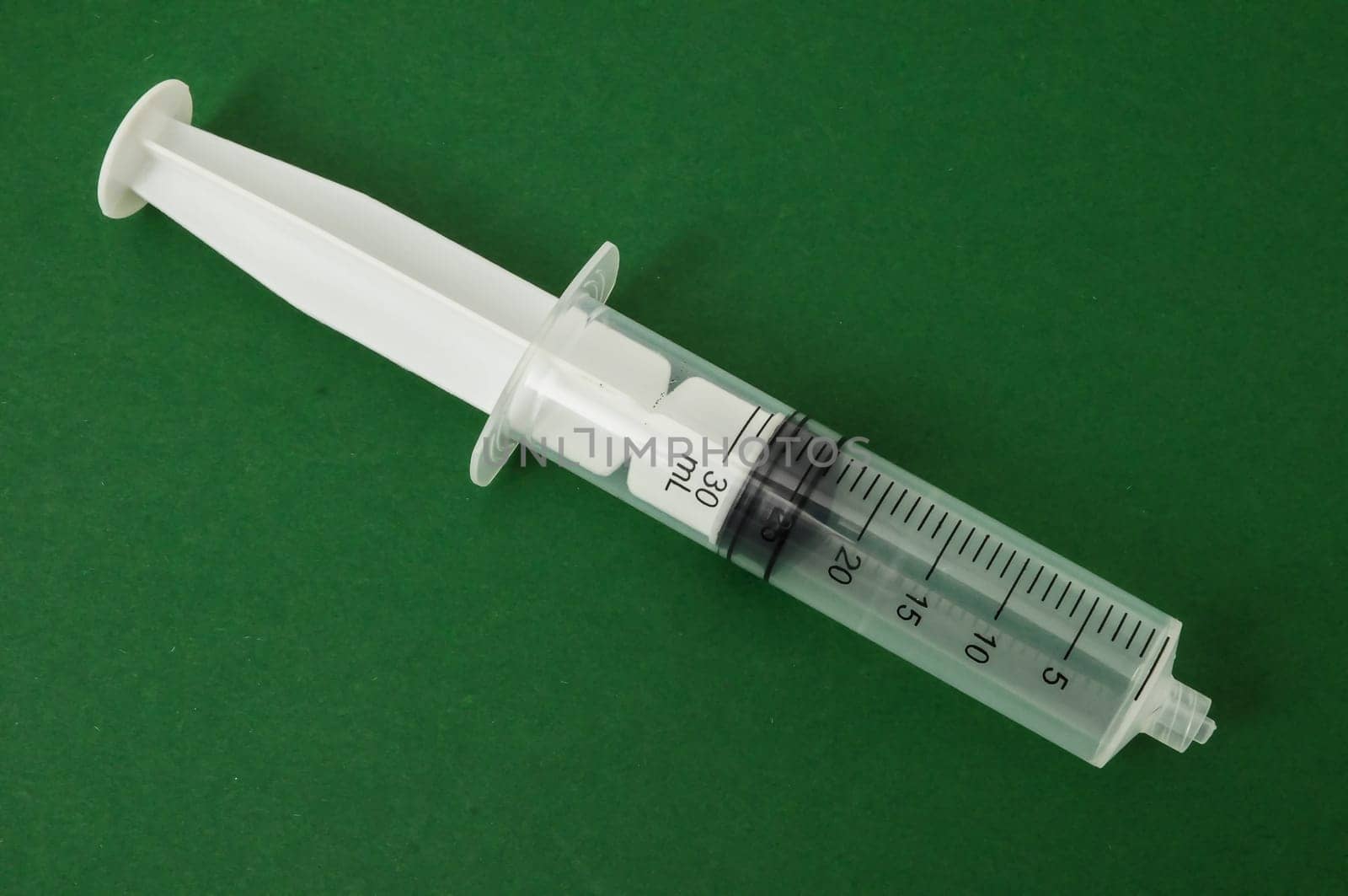 Big Black and White Syringe on a Colored Background