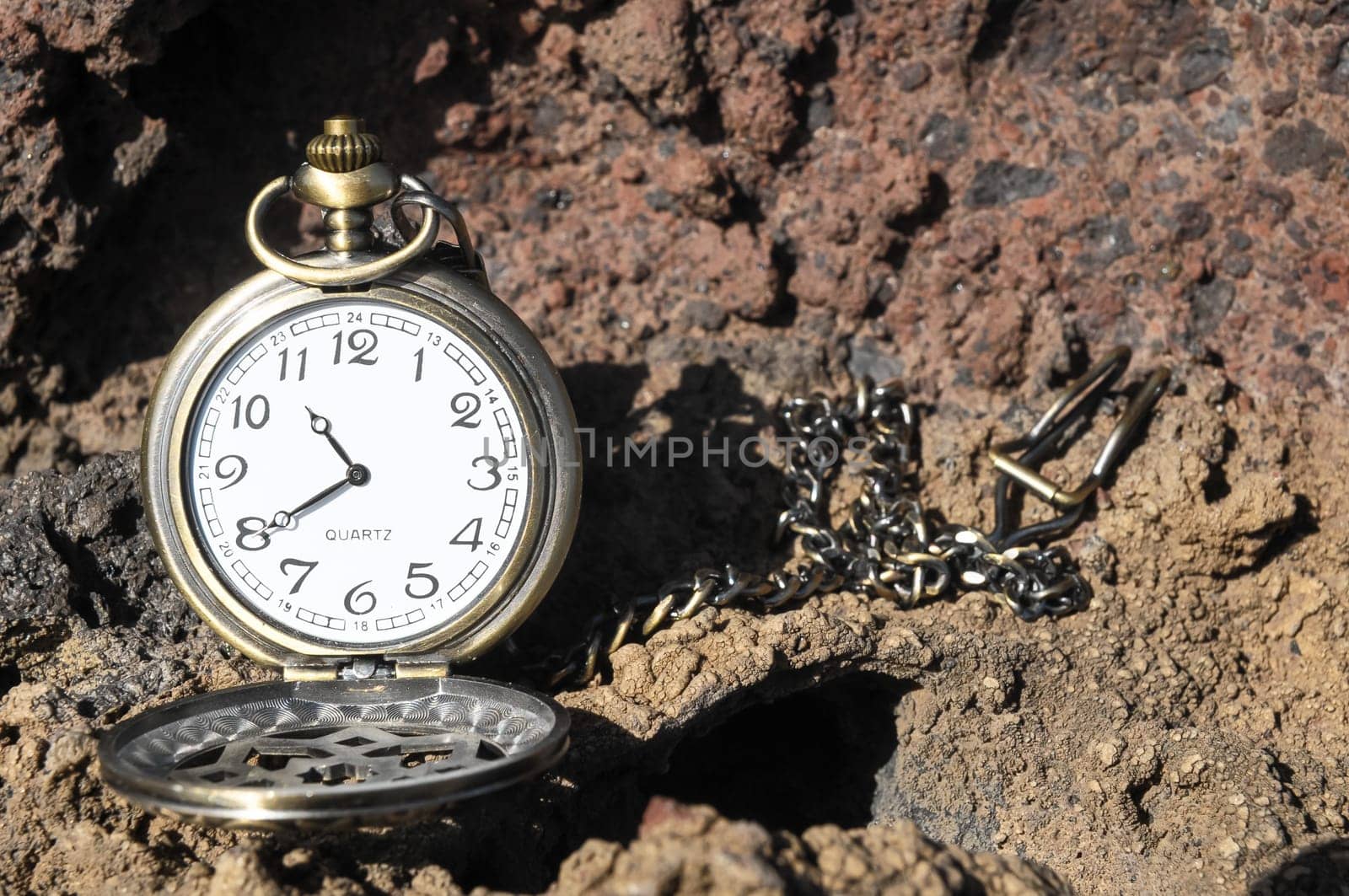 Time Concept Classic Vintage Pocket Clock on the Volcanic Rocks