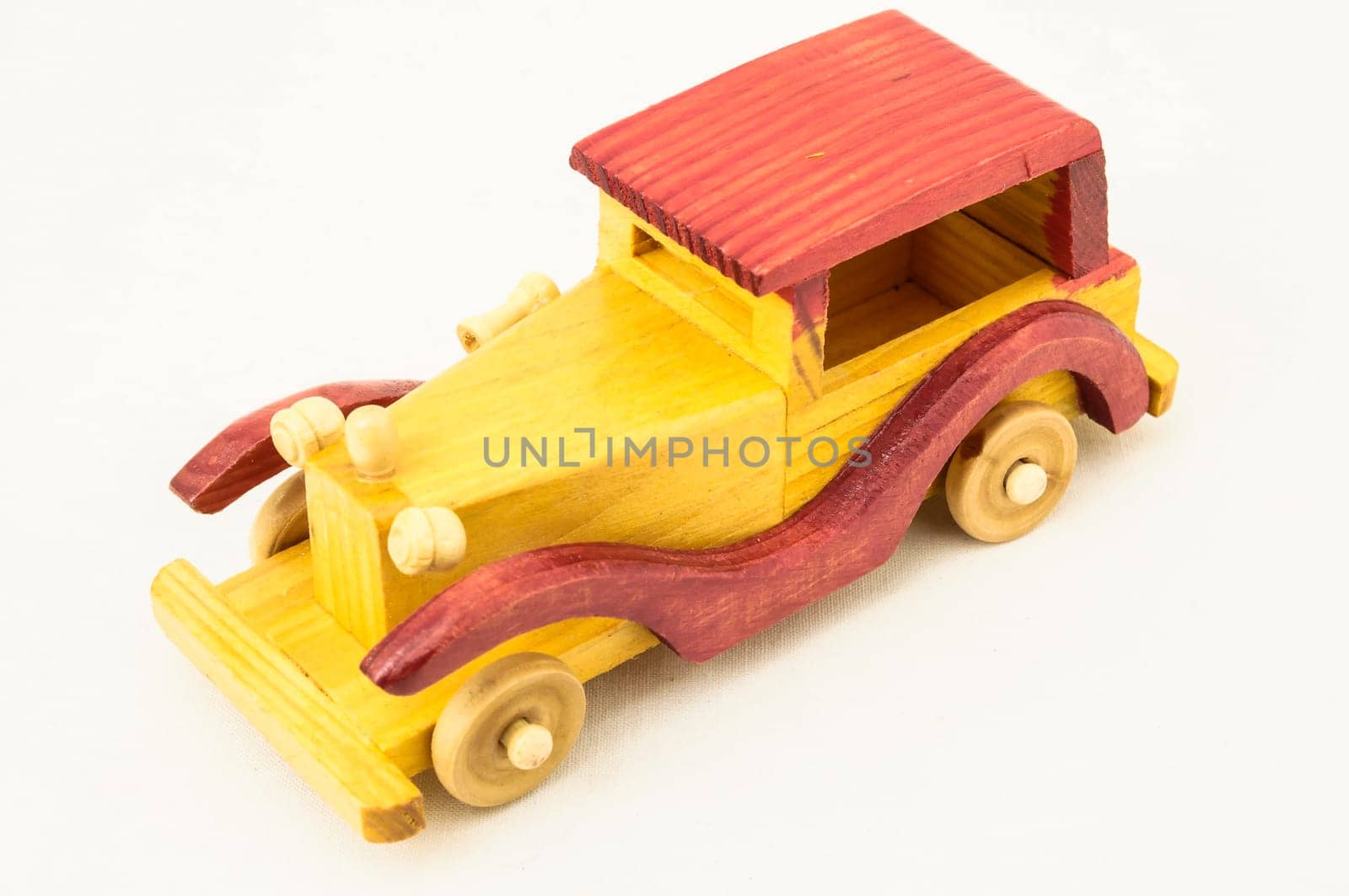 Wooden Toy Red and Yellow Car on a white Backgraund
