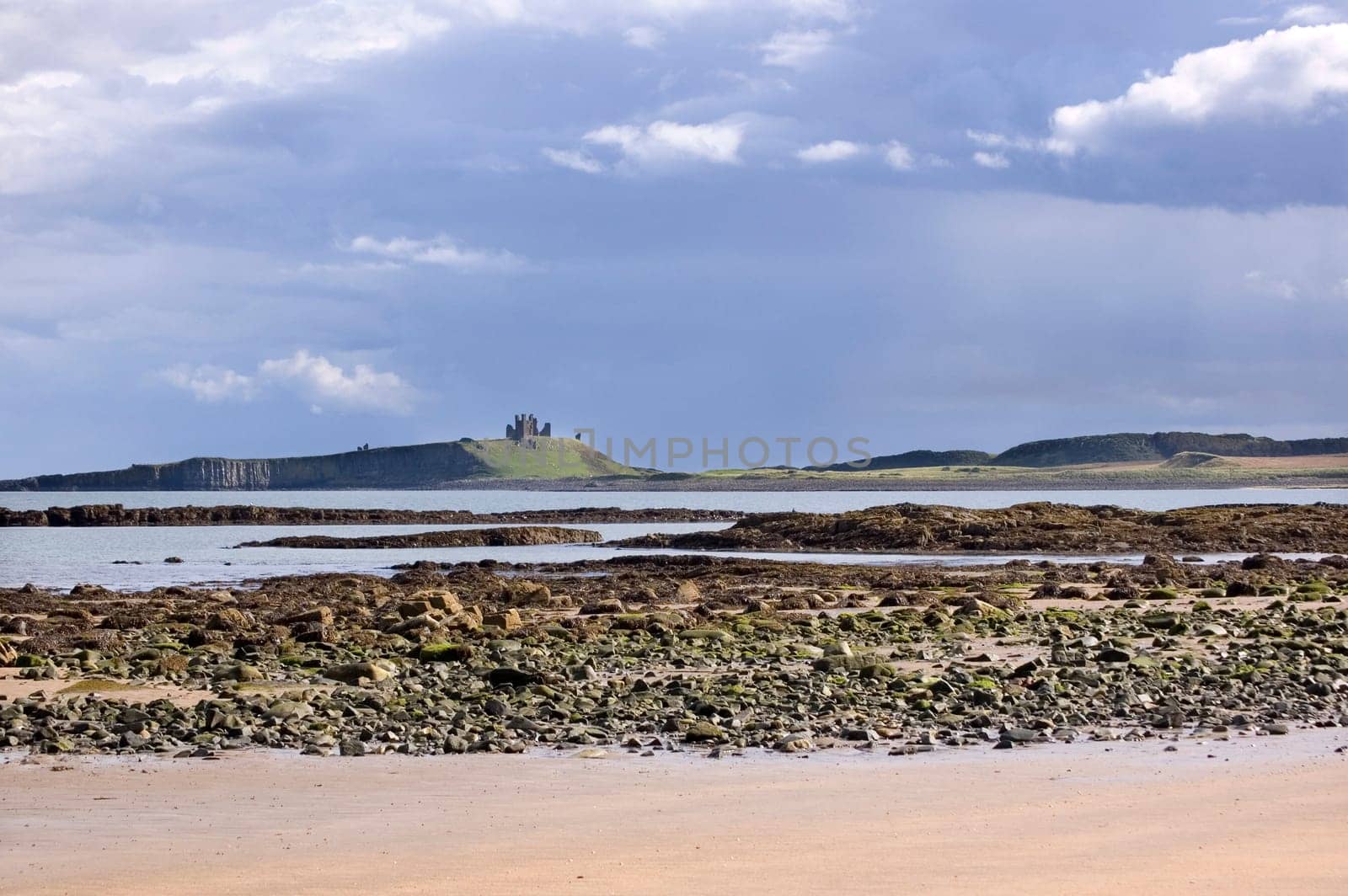 Dunstanburgh castle from beach of embleton bay