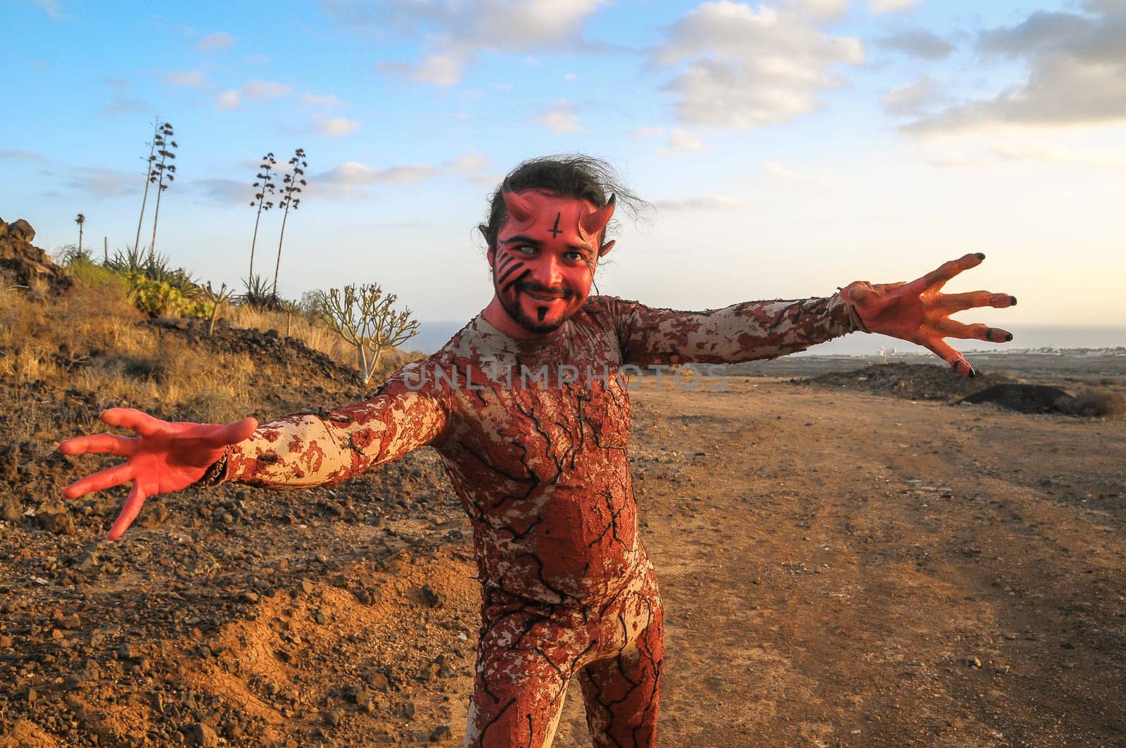 Latin American Man with Long Hairs Masked as a Devil in the Desert