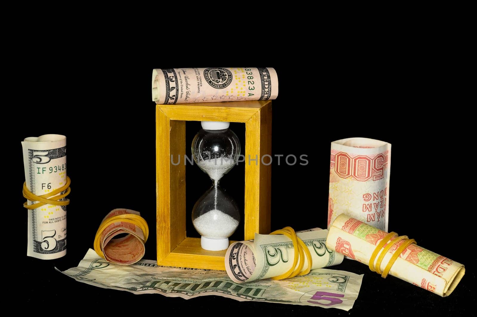 Buisness Time Concept Hourglass and Money on a Black Background