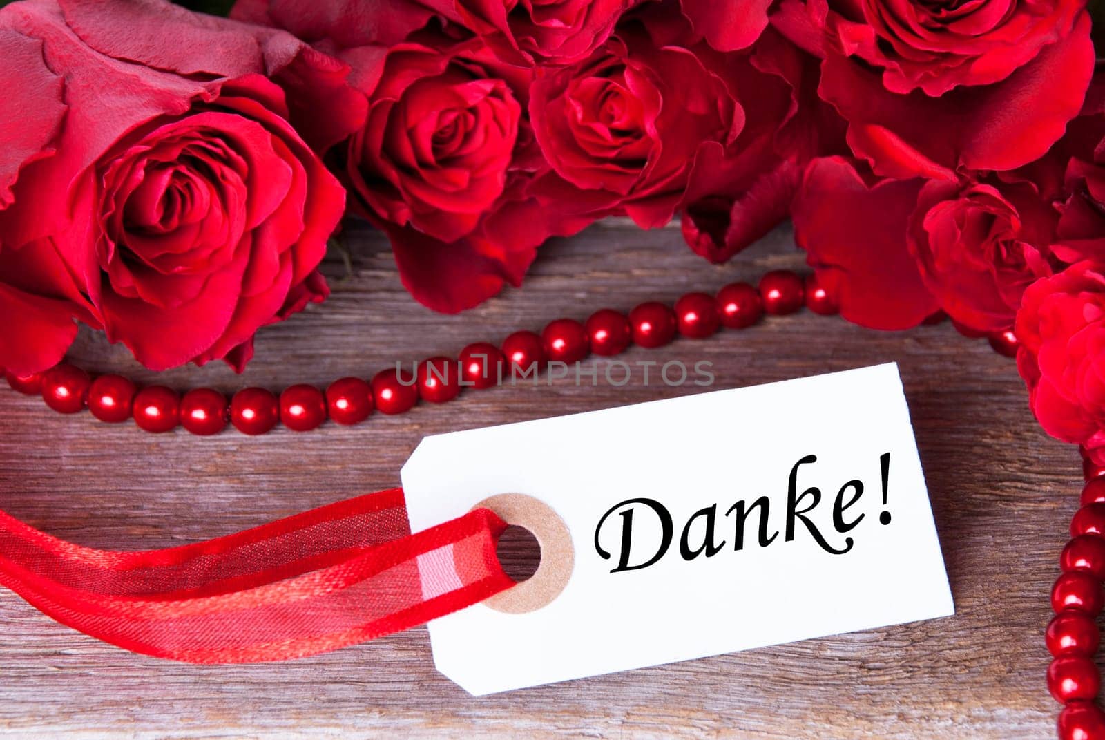 A Background with Roses and the German Word Danke which Means Thanks
